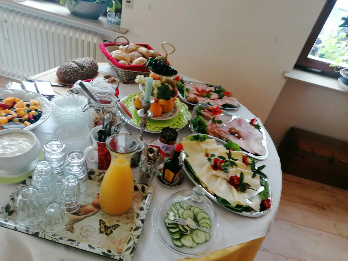 The lavishly laid breakfast buffet with fresh bread rolls, fruit, cheese and homemade jam
